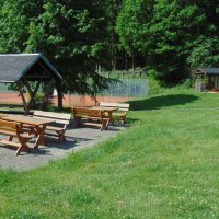 Grillplatz mit Feuerstelle und Tennisplatz im Hintergrund